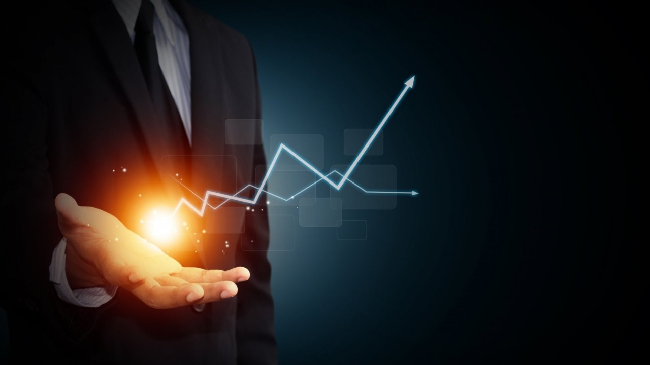 Business growth illustration showing an upward trend emerging from an outstretched hand.